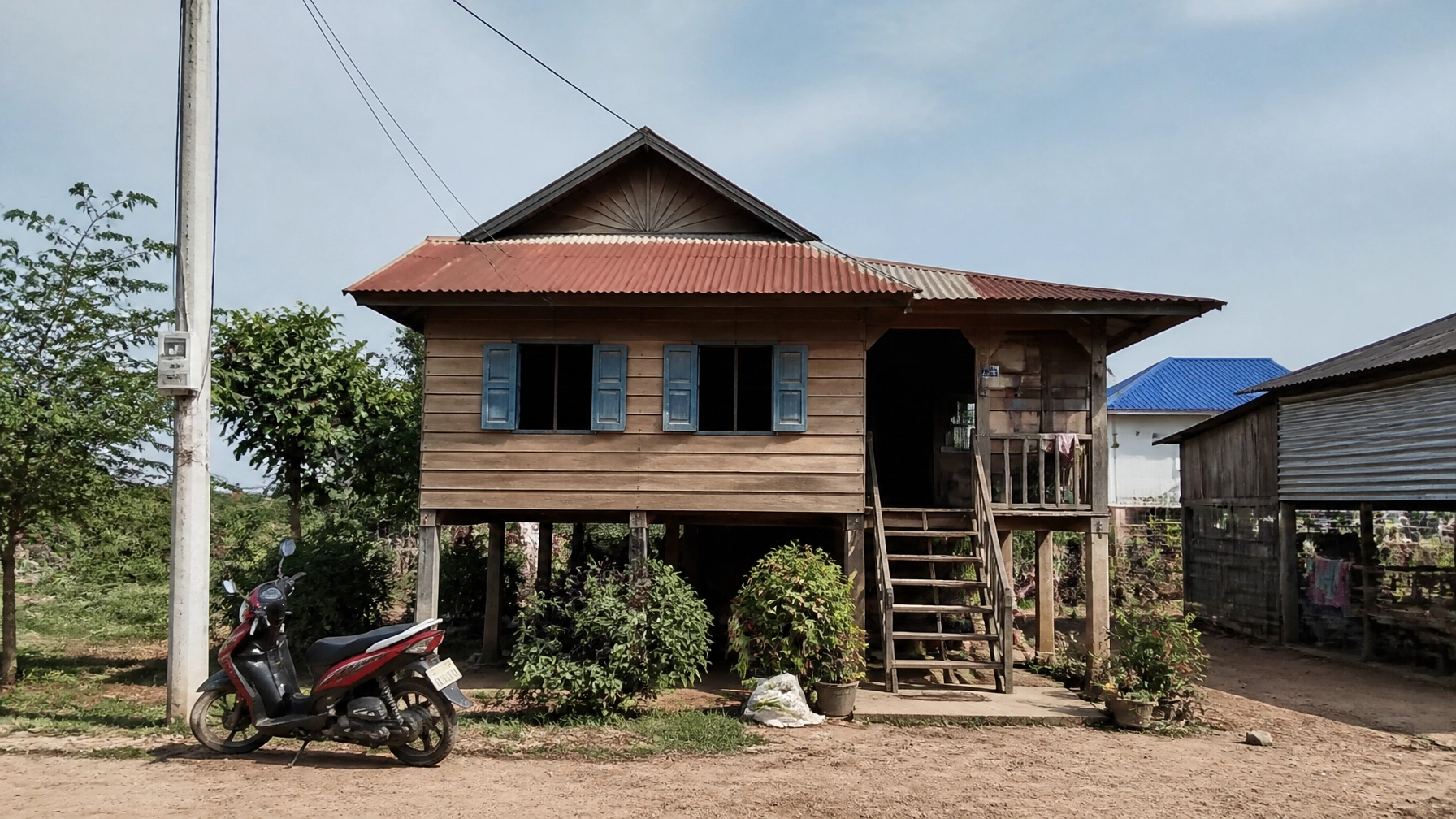 A simple wooden house in a Cambodian village near Phnom Penh, reflecting the home of a faithful widow.